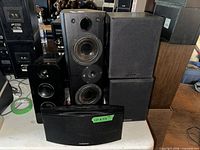 Group shot showing all five speakers: Wharfedale pair, Monster tower, LG curved speaker, Cerwin-Vega unit