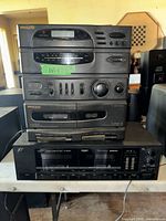 Front view showing stacked Philco components over Sansui D-1000W deck