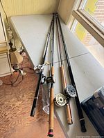 All four rods laid on table showing reels and handles
