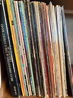 Stack of vinyl LP spines showing multiple titles with Bruce Springsteen box set