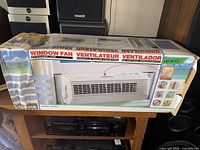 Front of boxed Holmes window fan ventilator