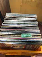Stack of approximately 30 vinyl LP albums showing spines and some cover art