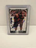 Front view of autographed Drake Batherson O-Pee-Chee card in plastic case