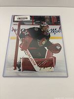 Front view of autographed Filip Gustavsson 8"x10" photo in protective sleeve