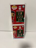 Rear view of stacked boxes showing Liverpool squad graphic and numbers 43, 53.