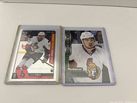 Front view of both Nick Paul rookie cards in sleeves