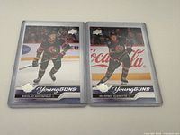 Fronts of both rookie cards in sleeves