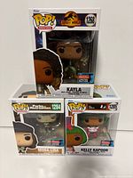 Front view of three boxed Funko Pops showing characters and edition stickers