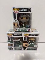 Front view of all three boxed figures displaying characters and numbers