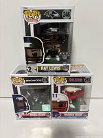 Front view of three boxed Funko Pop! Football figures: Ray Lewis on top, Russell Wilson and Warren Moon below