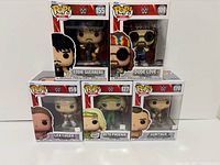 Front view of five Funko Pop WWE figures in boxes