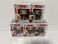 Five boxed WWE Funko Pop! figures stacked, showing fronts and numbering