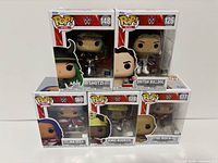 Front view of five boxed Funko Pop WWE figures