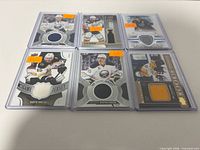 Front view of all six jersey cards in protectors