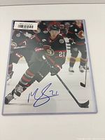 Full view of the autographed 8x10 photo in sleeve