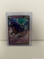 Front view of Shadow Rider Calyrex V card in sleeve and top loader