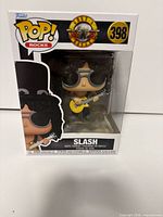 Front view of boxed Funko Pop Rocks Slash figure