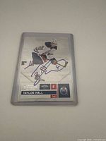 Front view of Panini Contenders Taylor Hall autograph card in plastic holder