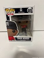 Front view of boxed Tiger Woods Funko Pop! displaying figure and branding