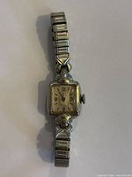 Front view of Longines square watch showing dial and bracelet