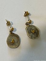 Full view of both earrings showing horn pads, gold nuggets, posts and ball studs