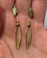 Front view of both earrings showing fan studs, detached marquise dangles and gold-tone finish