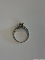 Top view of 18K white gold ring mounting showing crown setting and accent stones