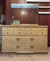 Front view of dresser with mirror, showing overall design and hardware
