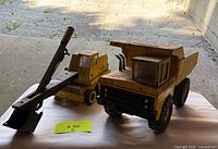 Both Tonka vehicles side by side on table