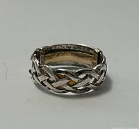 Front view of Celtic knot ring showing pattern and gold accents