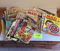 Stack of assorted comic books and MAD magazines on table