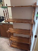 Full view of wooden etagere showing five shelves and turned spindles
