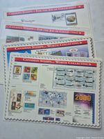 Front faces of four Canada Post display mats showing 1999 and 2000 stamp issue graphics