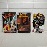 Front covers of the three Black Hammer graphic novels