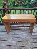 Front view of Thomasville hall table showing overall design and drawer