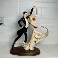 Front view of A. Santini ceramic tango dancing couple sculpture on wood base