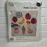 Front of sealed Golden Bee Plastic Canvas kit showing fruit and veggie magnet designs