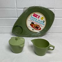 Sealed pack of 4 avocado plastic paper plate cup holders with Dorchester melmac cream and sugar set