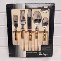 Front view of boxed Regent Sheffield Feeling7 20-piece cutlery set showing utensil styles and packaging labels