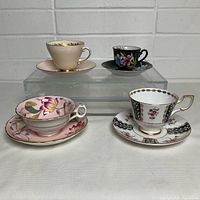 All four teacup and saucer pairs displayed