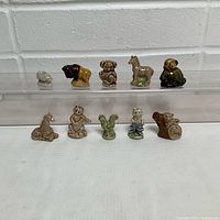 Ten Wade Red Rose Tea porcelain animal figurines displayed on two tiers