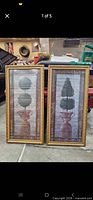 Both matching framed topiary prints side by side
