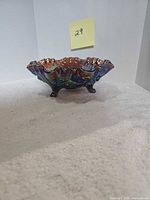 Side view of iridescent footed candy dish showing ruffled rim and feet