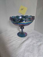 Full view of pedestal fruit bowl showing iridescent blue-violet color and scalloped rim