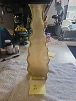 Front view showing wavy edged amber glass vase