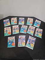 All 13 sealed Score 1990 NFL Football Series 1 packs displayed on table