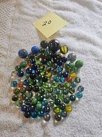 Group shot of entire assortment of glass marbles on towel