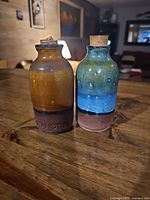 Front view of both stoneware jars showing glazes and corks