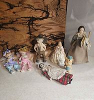 Group shot of all seven figurines displayed together