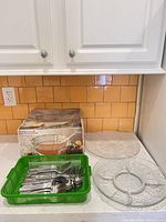 Box, punch bowl components visible on counter